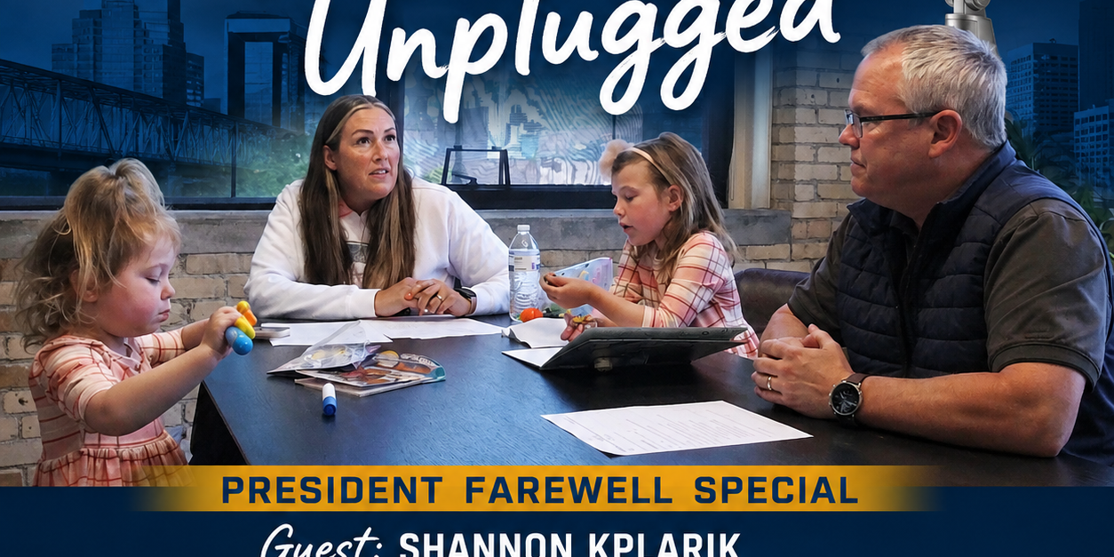 Promotional poster for Grand Rapids Rotary Unplugged featuring a panel at a table with microphones and a city backdrop, including Rotary branding.